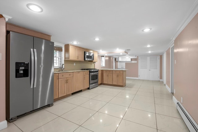 kitchen featuring a baseboard heating unit, a peninsula, a sink, light countertops, and appliances with stainless steel finishes