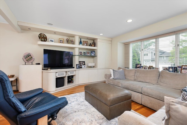 living area with recessed lighting and light wood finished floors