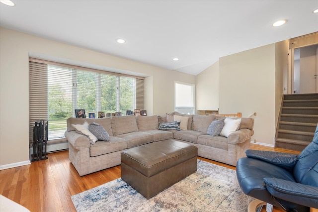 living area featuring stairs, baseboards, light wood-style flooring, and recessed lighting