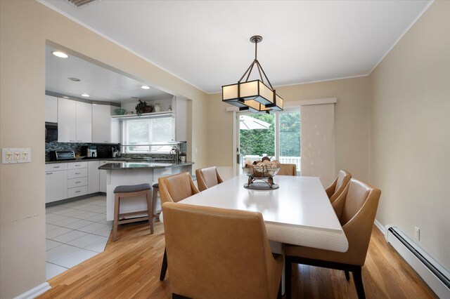 dining room with a toaster, recessed lighting, light wood-style flooring, baseboard heating, and ornamental molding