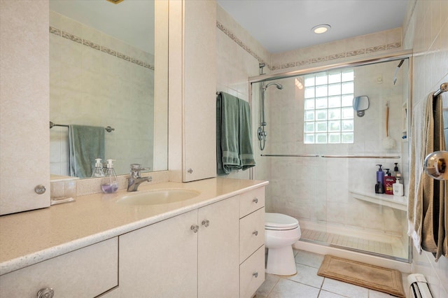 full bathroom featuring a stall shower, toilet, tile patterned floors, baseboard heating, and vanity