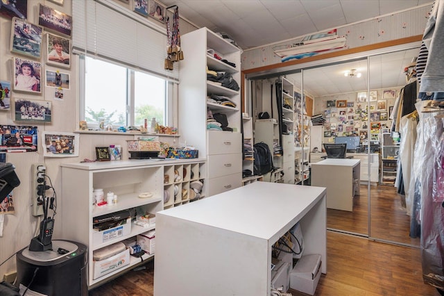 home office with wood finished floors and a workshop area