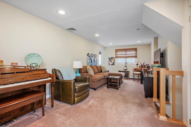 living area with light carpet, visible vents, and recessed lighting