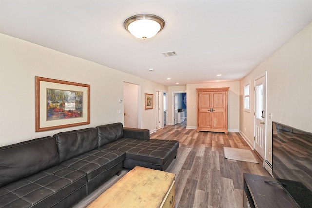 living area with recessed lighting, visible vents, baseboards, and wood finished floors