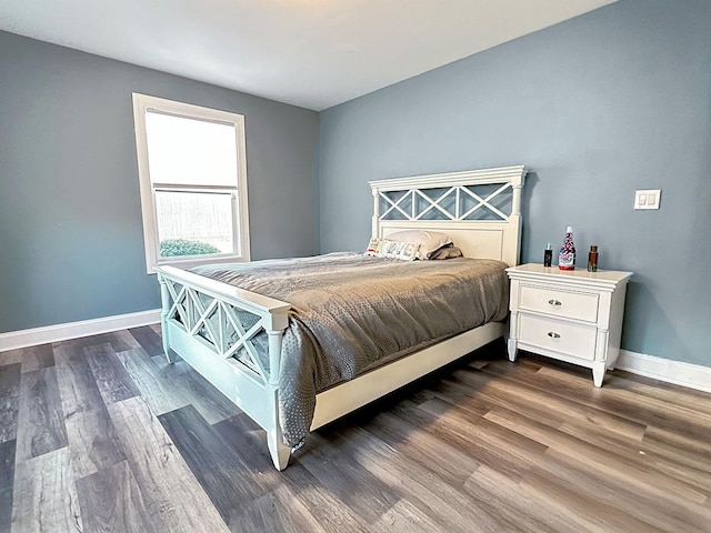 bedroom with dark wood-style floors and baseboards