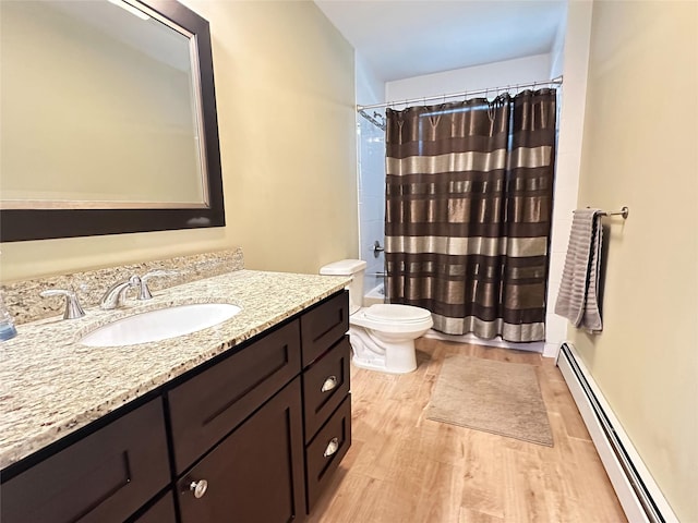 bathroom with a baseboard radiator, toilet, wood finished floors, vanity, and shower / bathtub combination with curtain