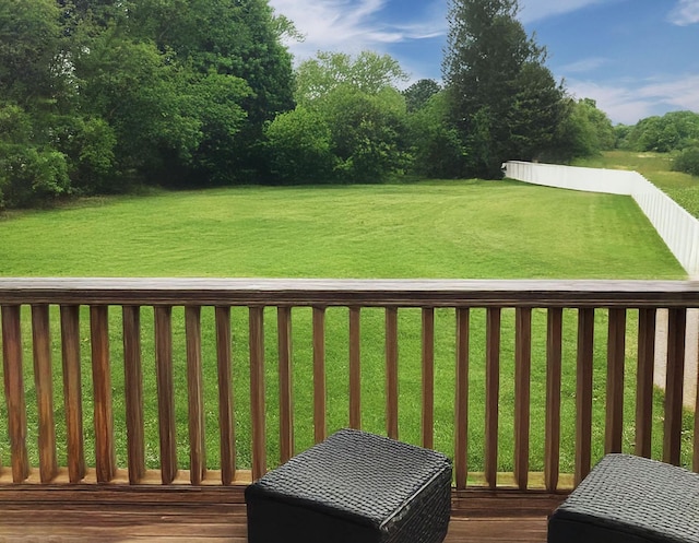 wooden deck featuring a yard