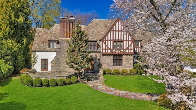 31 Old Army Rd, Scarsdale, NY 10583 - back of property with stucco siding, stone siding, a lawn, and a chimney