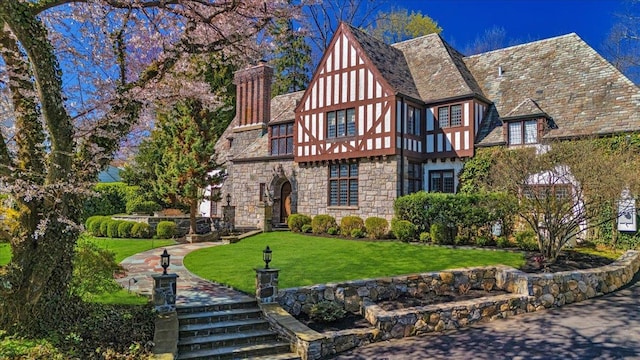 31 Old Army Rd, Scarsdale, NY 10583 - view of front of property with a front yard, stone siding, and a chimney