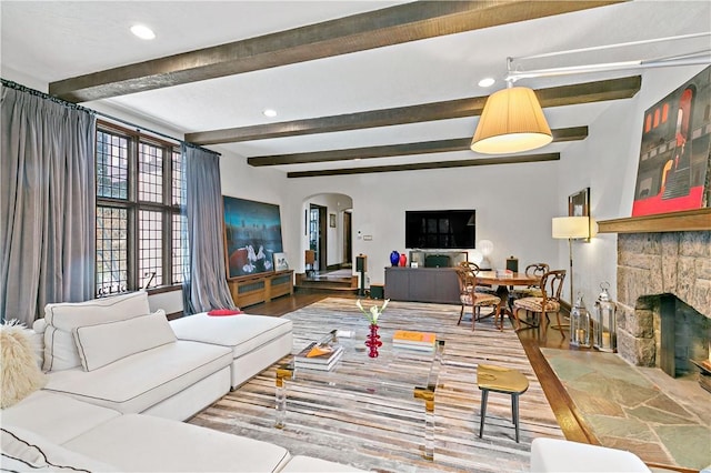 31 Old Army Rd, Scarsdale, NY 10583 - living area featuring a stone fireplace, recessed lighting, beam ceiling, arched walkways, and wood finished floors