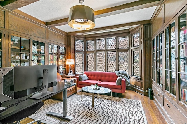 31 Old Army Rd, Scarsdale, NY 10583 - sunroom with a textured ceiling, wooden walls, beamed ceiling, wood finished floors, and french doors