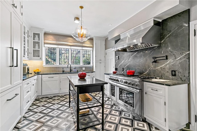 31 Old Army Rd, Scarsdale, NY 10583 - kitchen with wall chimney exhaust hood, a sink, dark countertops, double oven range, and decorative backsplash