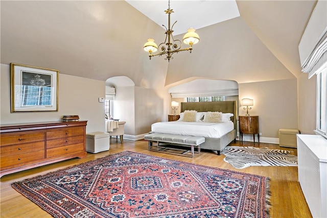31 Old Army Rd, Scarsdale, NY 10583 - bedroom with baseboards, arched walkways, an inviting chandelier, wood finished floors, and high vaulted ceiling