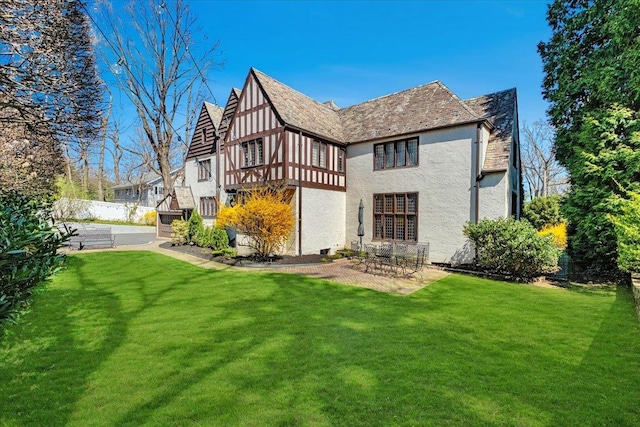 31 Old Army Rd, Scarsdale, NY 10583 - back of house with a patio, stucco siding, and a lawn