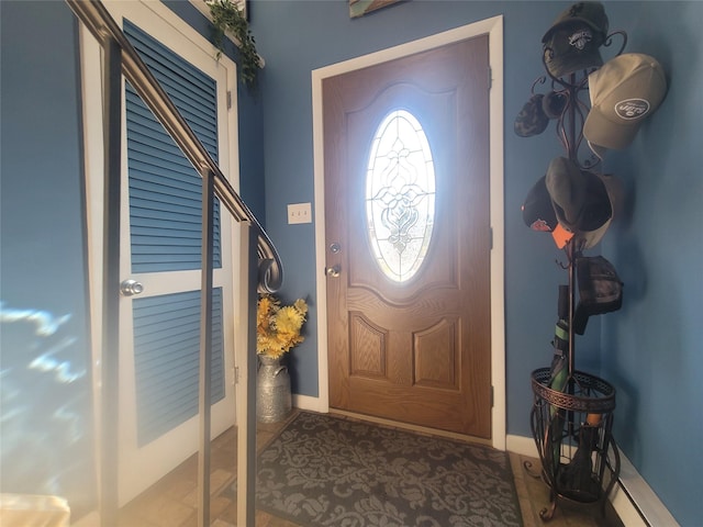 entryway featuring a baseboard radiator and baseboards