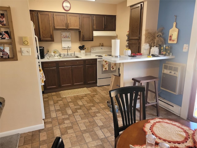 kitchen with electric range, a peninsula, light countertops, under cabinet range hood, and a sink