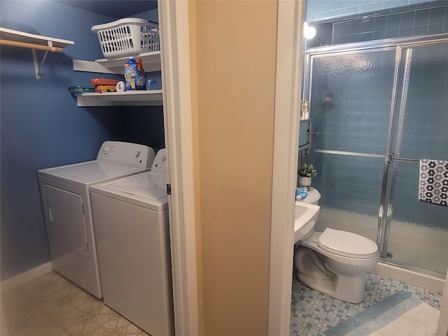 laundry area with laundry area, tile patterned floors, baseboards, and washing machine and clothes dryer