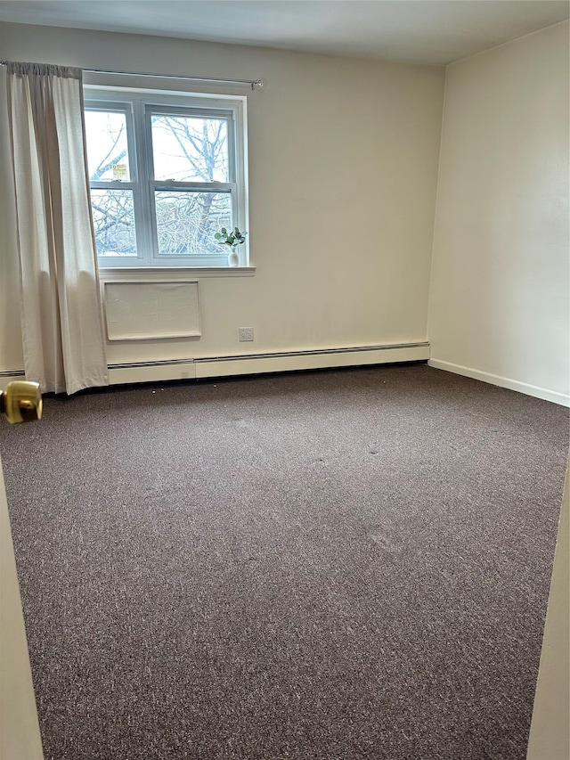 spare room with carpet and baseboards