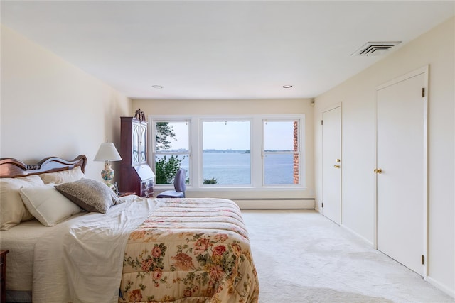 bedroom featuring light colored carpet, visible vents, and a baseboard radiator