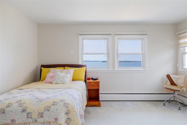 carpeted bedroom featuring baseboard heating