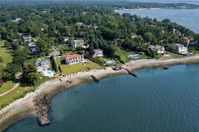 birds eye view of property with a water view and a wooded view