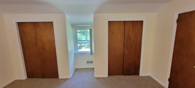 unfurnished bedroom featuring carpet flooring, visible vents, and baseboards