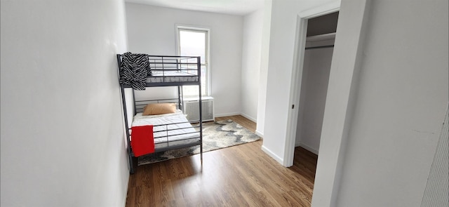 bedroom with baseboards and wood finished floors