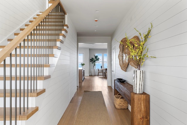 hall featuring stairs and wood finished floors