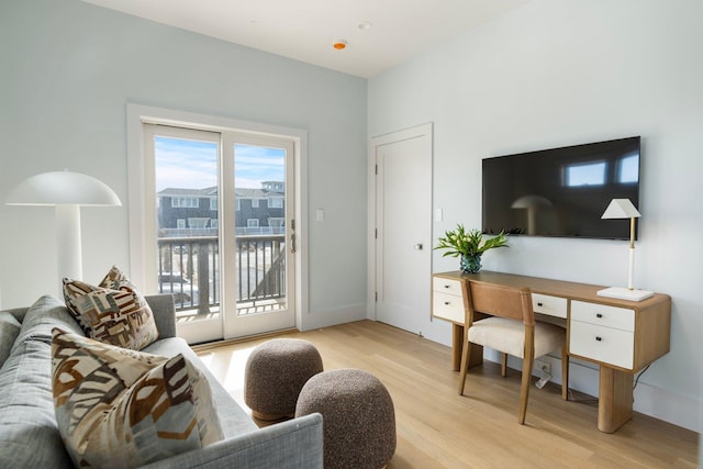 living room with light wood-style flooring and baseboards