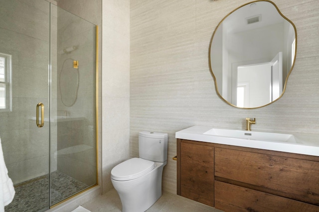 full bathroom featuring toilet, a stall shower, vanity, and visible vents