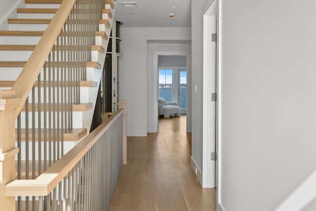 hall with wood-type flooring and visible vents