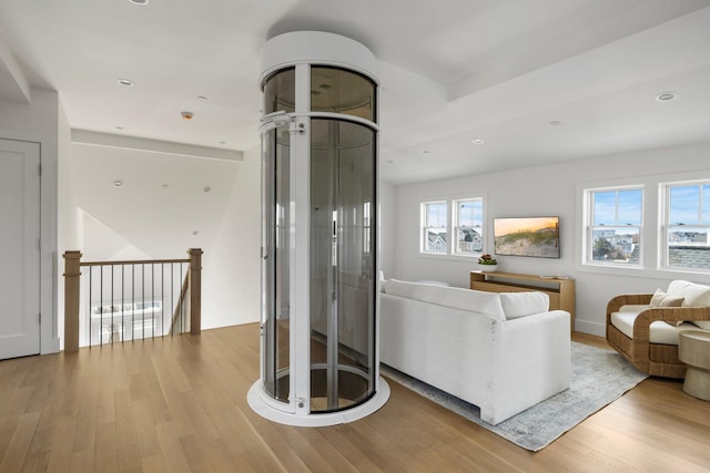 living area featuring wood finished floors and recessed lighting