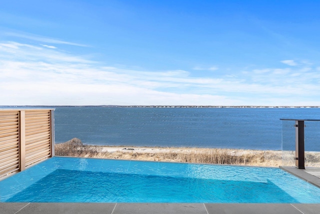 view of pool with a water view