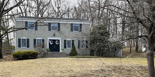 colonial home with a front lawn