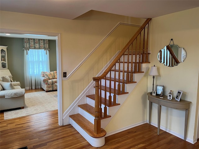 stairs featuring baseboards and wood finished floors