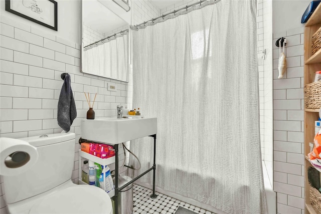 full bathroom with shower / bath combo, backsplash, tile walls, and toilet