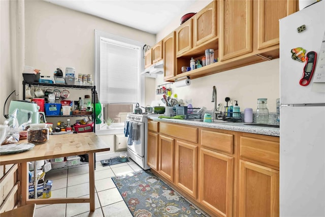 kitchen featuring tile patterned flooring, under cabinet range hood, white appliances, a sink, and light countertops