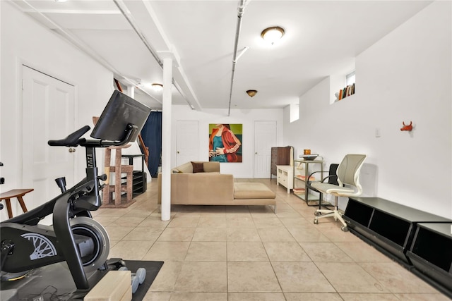 workout room featuring light tile patterned floors