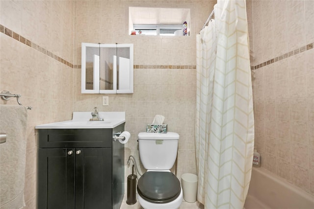 bathroom featuring vanity, toilet, and tile walls