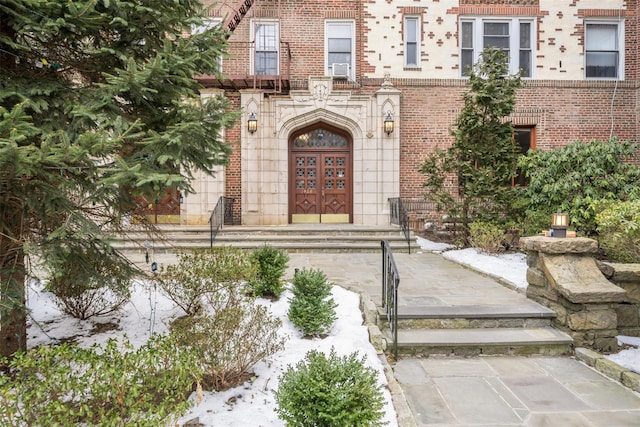 doorway to property with brick siding