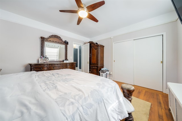 bedroom with a ceiling fan, a closet, and hardwood / wood-style flooring