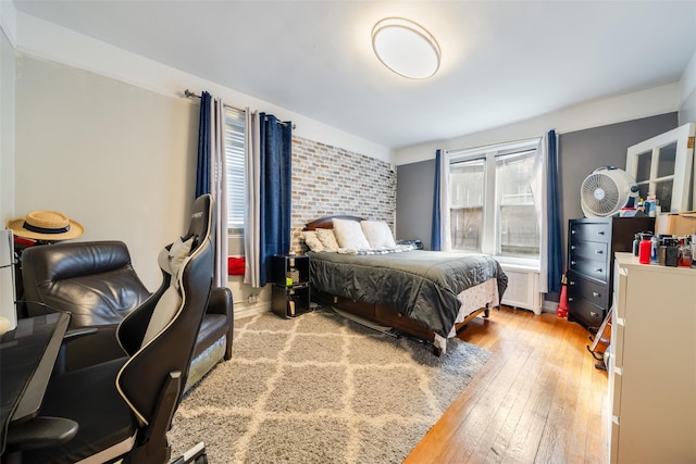 bedroom with hardwood / wood-style flooring