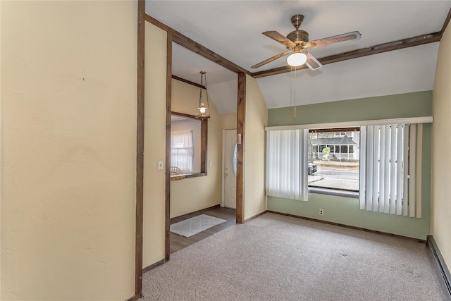 spare room with carpet, baseboards, vaulted ceiling, and a wealth of natural light