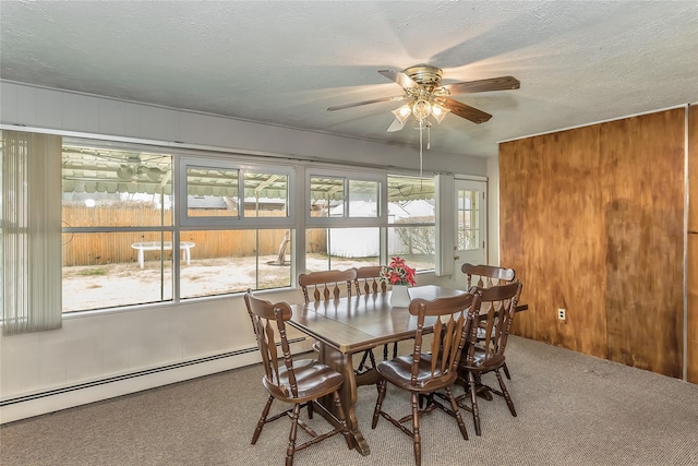 dining space with carpet flooring, ceiling fan, a textured ceiling, and baseboard heating