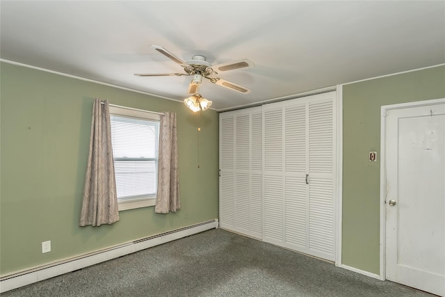 unfurnished bedroom featuring a baseboard radiator, dark carpet, ceiling fan, and a closet