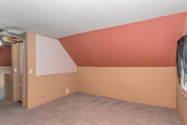 bonus room with light carpet, visible vents, and lofted ceiling