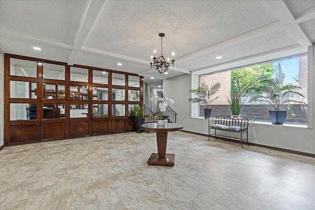 interior space featuring coffered ceiling, a textured ceiling, baseboards, and an inviting chandelier