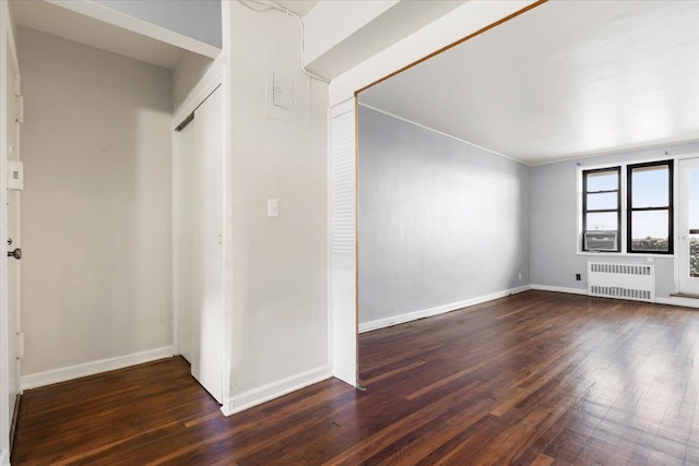 interior space featuring radiator, baseboards, and hardwood / wood-style floors