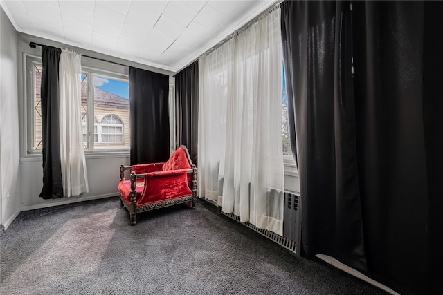 sitting room with ornamental molding, carpet flooring, and baseboards