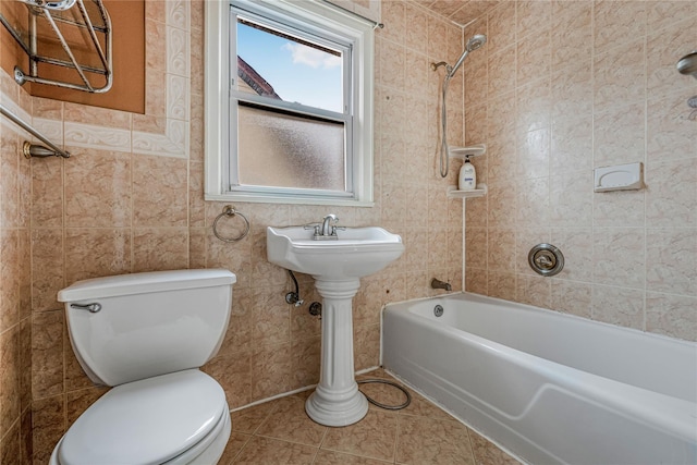 bathroom featuring toilet, tile patterned flooring, and  shower combination